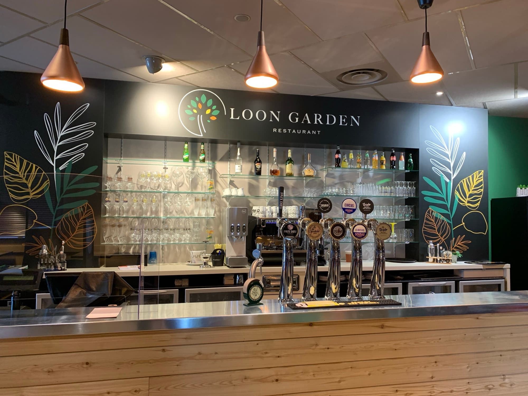 The Loon Garden bar: illuminated sign, copper pendant lights, botanical murals and beer taps