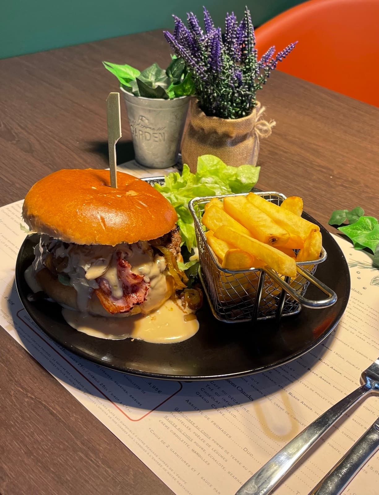 Homemade bacon burger with sauce, fries served in a basket