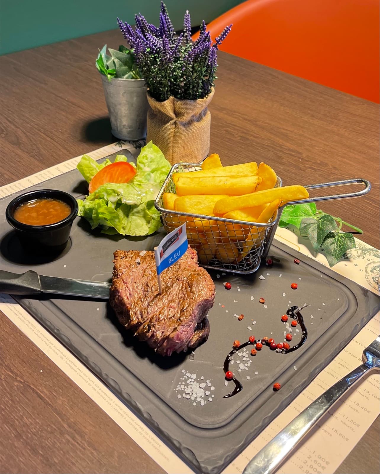 Rare butcher's cut on a slate, with fries and salad